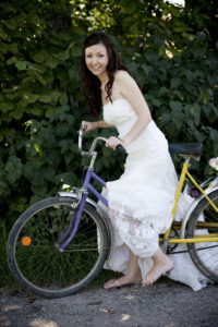 bride in white wedding dress on retro bike